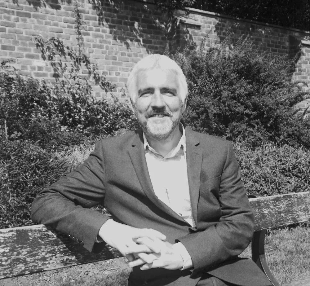 John Britton seated outdoors